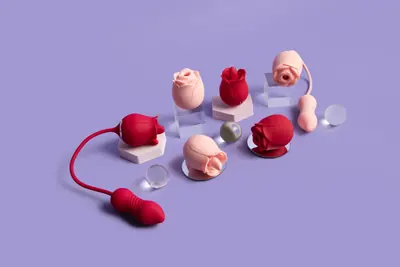 Red and blush-pink rose-shaped devices arranged on pale display blocks against a lilac background
