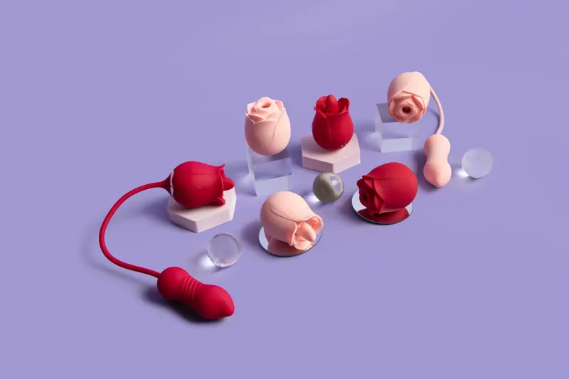 Red and blush-pink rose-shaped devices arranged on pale display blocks against a lilac background