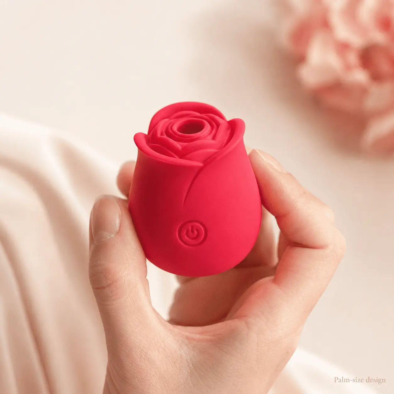 Roselle Classic rose toy held gently in a hand against a soft, warm background