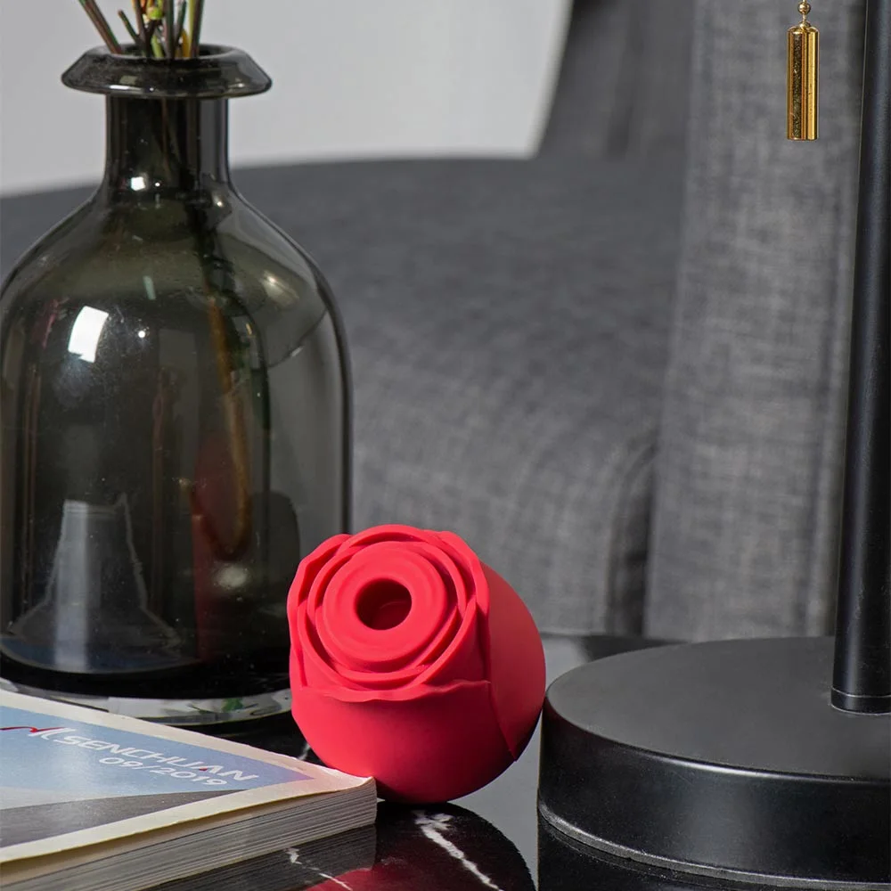 Roselle Bloom Rose Suction Toy — red rose toy on bedside table