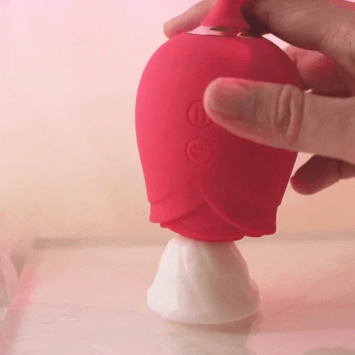 Roselle Motion Thrusting Rose Vibrator — handheld rose vibrator on charging base