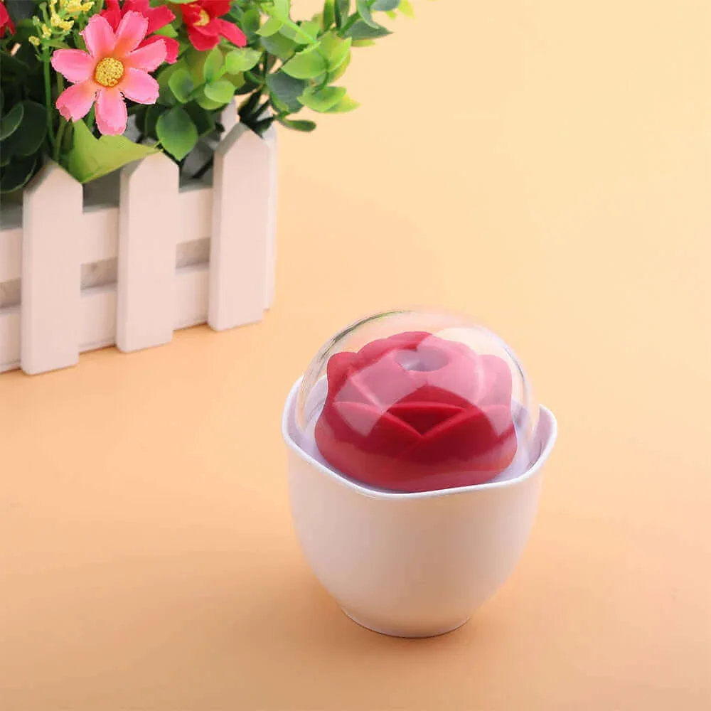 Roselle Nest Compact Rose Suction Toy — closed cup beside flowers